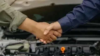 The mechanic shaking hands with customer after finish checking car system.Professional service.checking the opened hood car.Repair service.